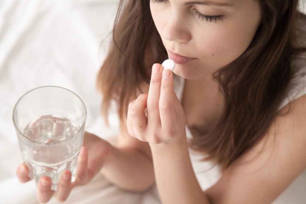 woman taking medication